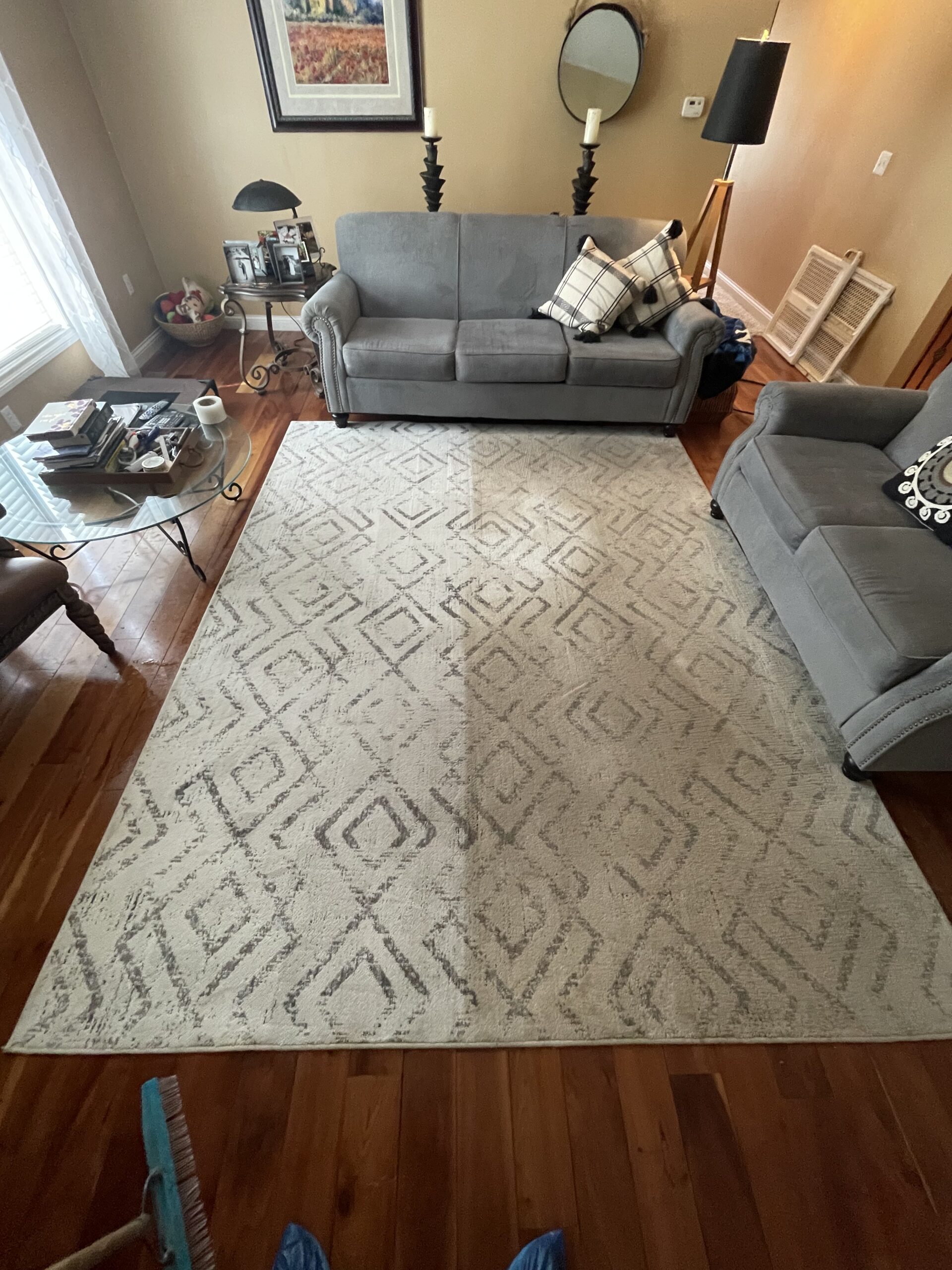 Area rug partially cleaned showing the difference during professional cleaning by Triton Steam Cleaning